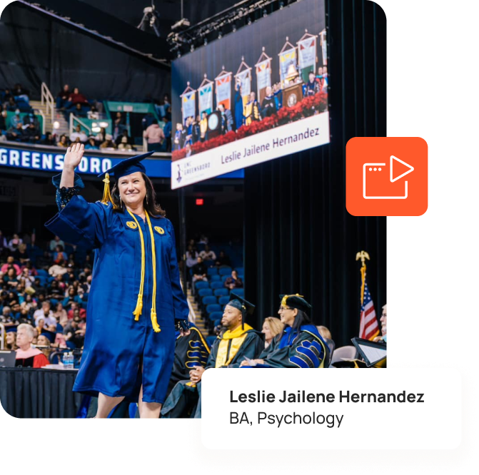Graduate on stage with personalized display banner