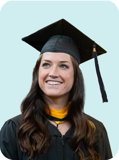 Female graduate in cap and gown with yellow stole smiling